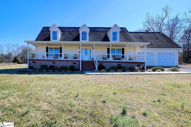 view of front of property featuring a garage, a front lawn, and a porch