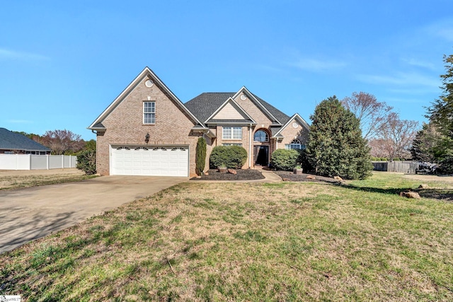 traditional-style home with a garage, brick siding, fence, driveway, and a front lawn