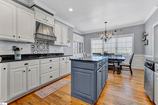 kitchen featuring premium range hood, white cabinetry, dishwasher, light wood finished floors, and dark countertops