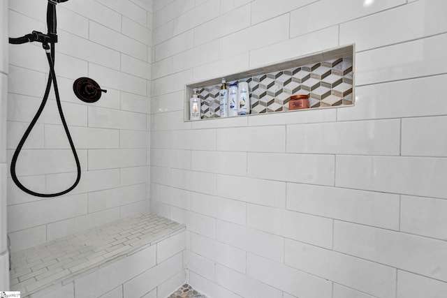 full bath with a tile shower