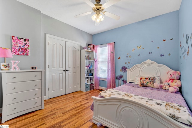 bedroom with a ceiling fan, light wood-type flooring, and a closet