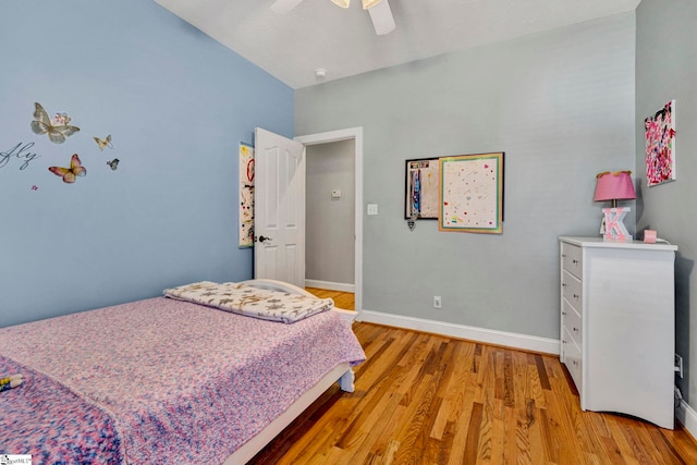 bedroom featuring light wood-type flooring, a ceiling fan, and baseboards