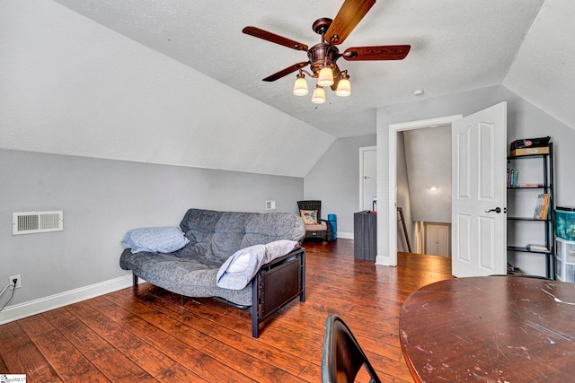 living room with lofted ceiling, baseboards, visible vents, and hardwood / wood-style floors