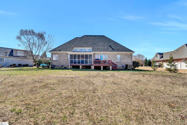 back of property with cooling unit, brick siding, a sunroom, a lawn, and crawl space