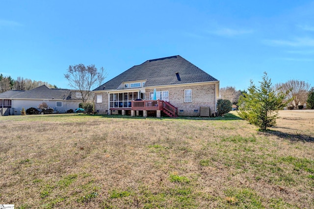 back of property featuring brick siding, a lawn, stairway, crawl space, and a deck