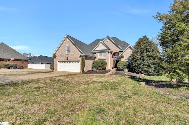 traditional home featuring brick siding, concrete driveway, a front yard, fence, and a garage