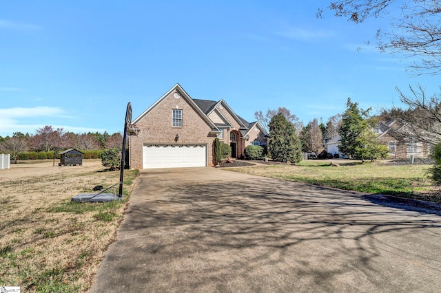 traditional-style house with brick siding, driveway, and a front lawn