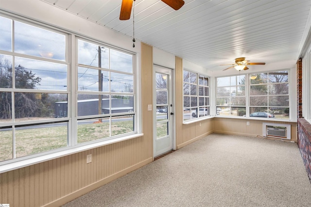 unfurnished sunroom with a ceiling fan