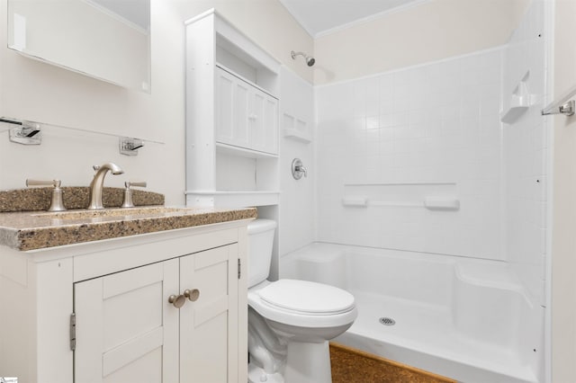 bathroom featuring ornamental molding, vanity, toilet, and walk in shower