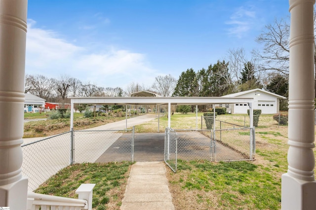 view of parking featuring fence and a gate