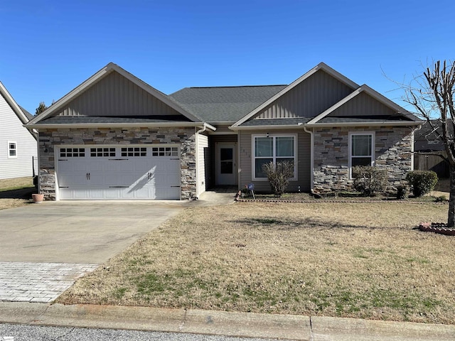 craftsman inspired home with a garage, concrete driveway, stone siding, a front lawn, and board and batten siding