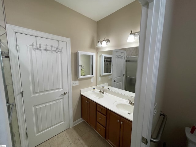 bathroom featuring double vanity, tile patterned flooring, and a sink