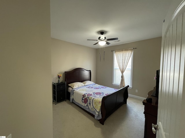 bedroom featuring a ceiling fan, light colored carpet, visible vents, and baseboards