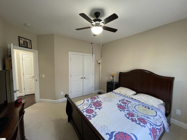 carpeted bedroom featuring a closet, a ceiling fan, and baseboards