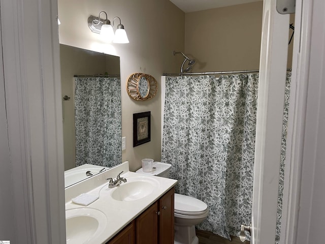 bathroom featuring toilet, double vanity, a sink, and a shower with shower curtain