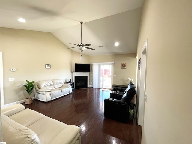 living area with lofted ceiling, dark wood-type flooring, a fireplace, a ceiling fan, and baseboards