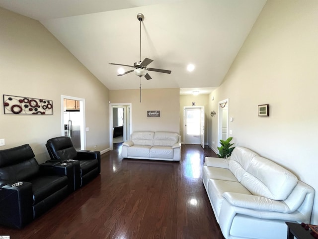 living area featuring ceiling fan, high vaulted ceiling, dark wood-type flooring, and baseboards