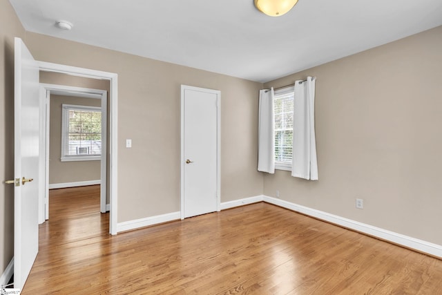 unfurnished bedroom featuring light wood-type flooring and baseboards