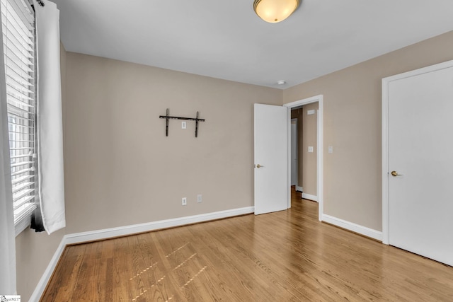 unfurnished bedroom featuring baseboards and wood finished floors