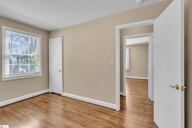 unfurnished bedroom featuring baseboards and wood finished floors