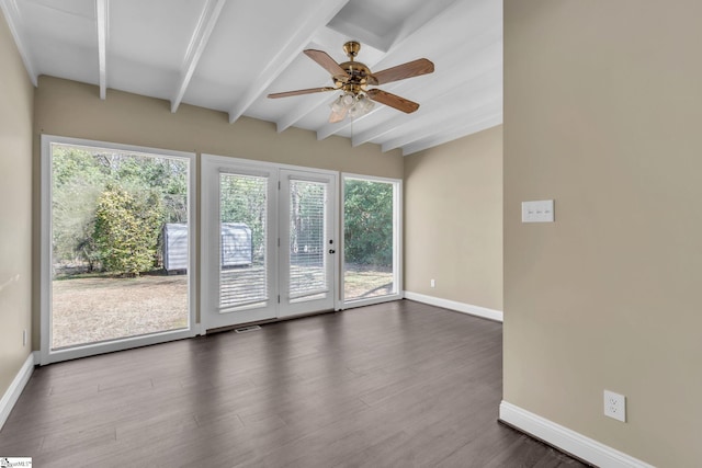 unfurnished room featuring a ceiling fan, baseboards, dark wood-style flooring, and beamed ceiling