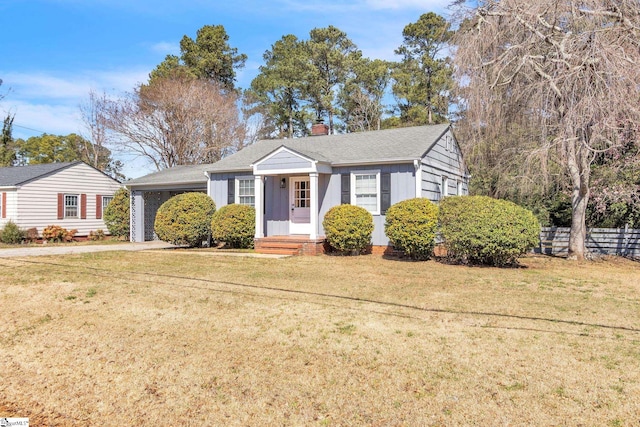 bungalow-style home with board and batten siding, a front yard, fence, and a chimney