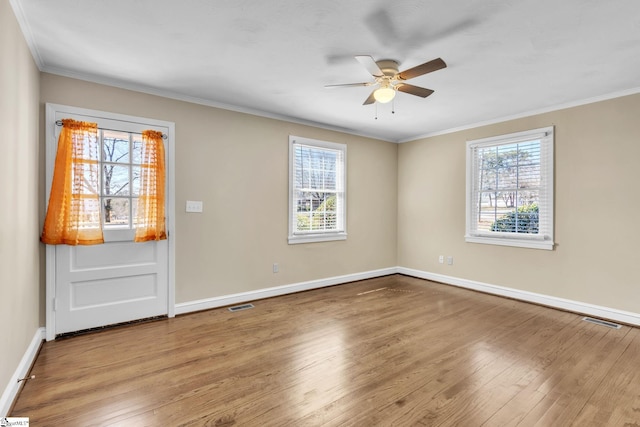 interior space with a healthy amount of sunlight, visible vents, and wood finished floors