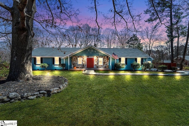 view of front of home featuring a yard and stone siding