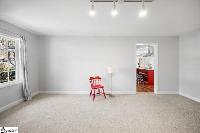 interior space featuring carpet floors and baseboards