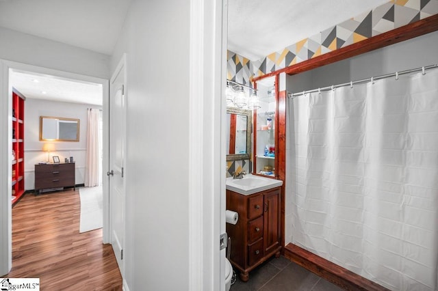 full bathroom with wood finished floors, vanity, and a shower with curtain