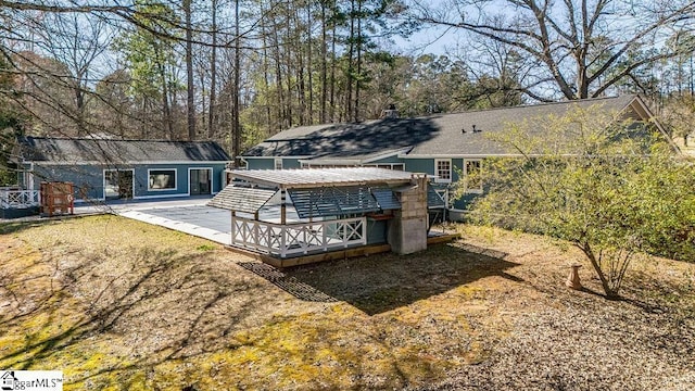 rear view of house with a wooden deck