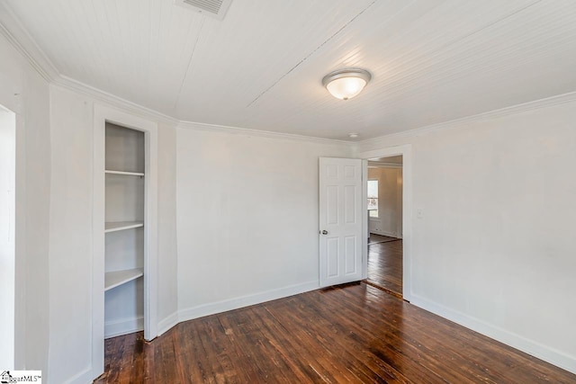 empty room featuring built in shelves, visible vents, baseboards, ornamental molding, and hardwood / wood-style floors