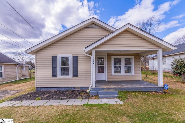 bungalow-style house with covered porch and a front yard