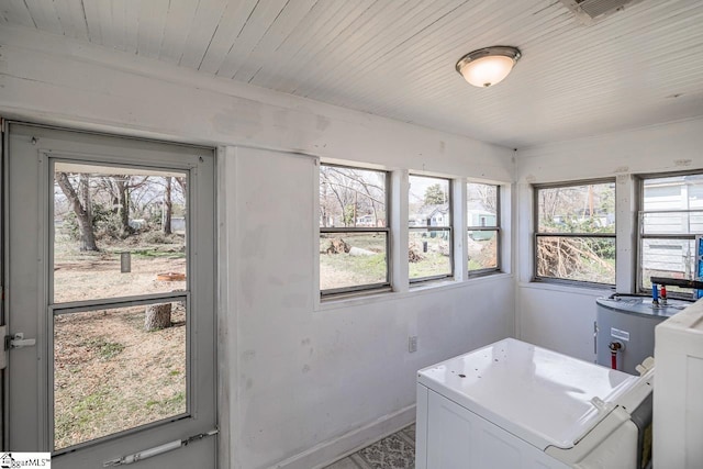 washroom featuring laundry area, washer / clothes dryer, wood ceiling, and baseboards