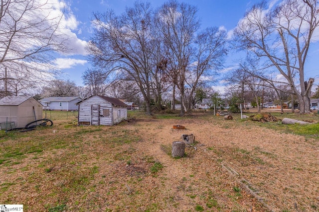 view of yard with a storage shed and an outbuilding