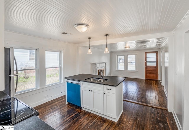 kitchen with dishwasher, dark countertops, ornamental molding, freestanding refrigerator, and a sink