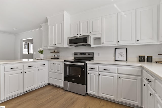 kitchen featuring white cabinets, appliances with stainless steel finishes, light countertops, crown molding, and light wood-style floors