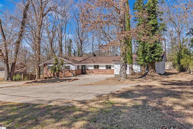 view of front of property featuring concrete driveway and brick siding