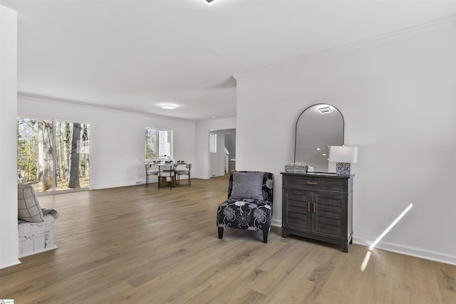 sitting room featuring crown molding, wood finished floors, and baseboards