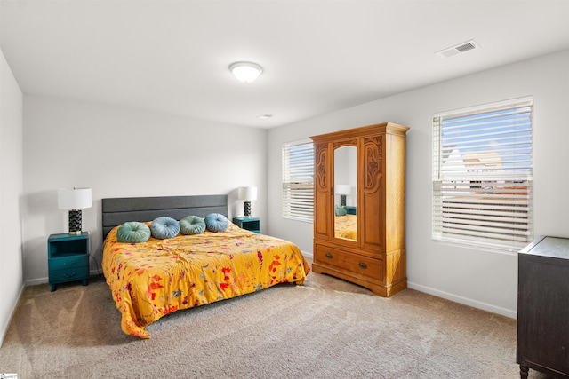 bedroom featuring baseboards, visible vents, and carpet flooring