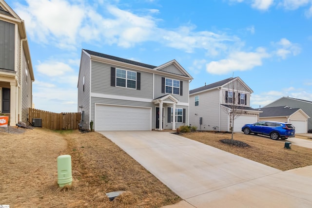 traditional-style home featuring central AC unit, an attached garage, fence, driveway, and board and batten siding