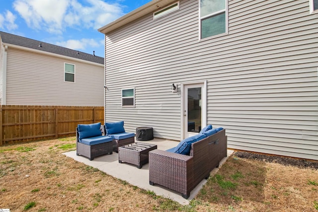 rear view of property featuring fence, a patio, and an outdoor hangout area