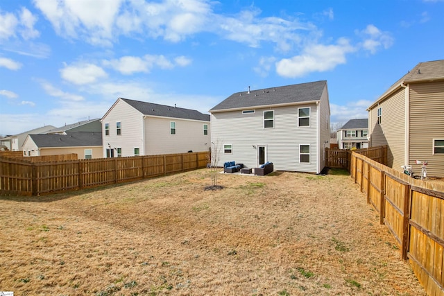 rear view of house with a residential view and a fenced backyard