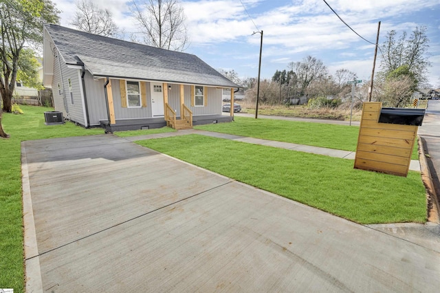 view of front of property with crawl space, a shingled roof, a front lawn, and cooling unit