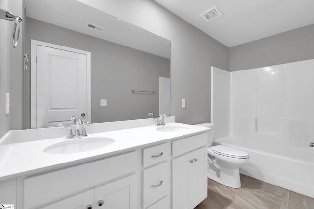 bathroom with toilet, a sink, and visible vents