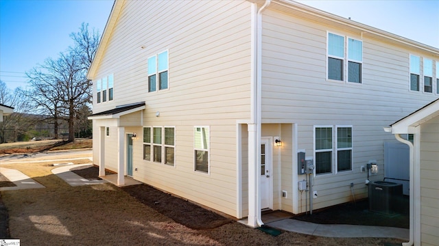 back of property featuring central air condition unit