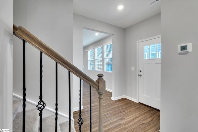 entrance foyer with plenty of natural light, wood finished floors, visible vents, and baseboards