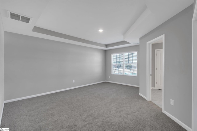 unfurnished room featuring recessed lighting, carpet floors, visible vents, baseboards, and a tray ceiling