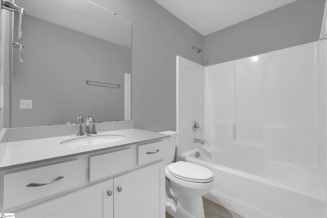 bathroom featuring toilet, shower / bathing tub combination, and vanity