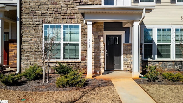 entrance to property featuring stone siding